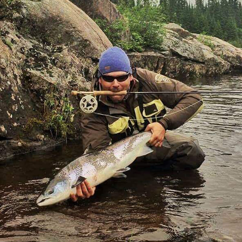 Image of David Hartlin with a large fish in a lake