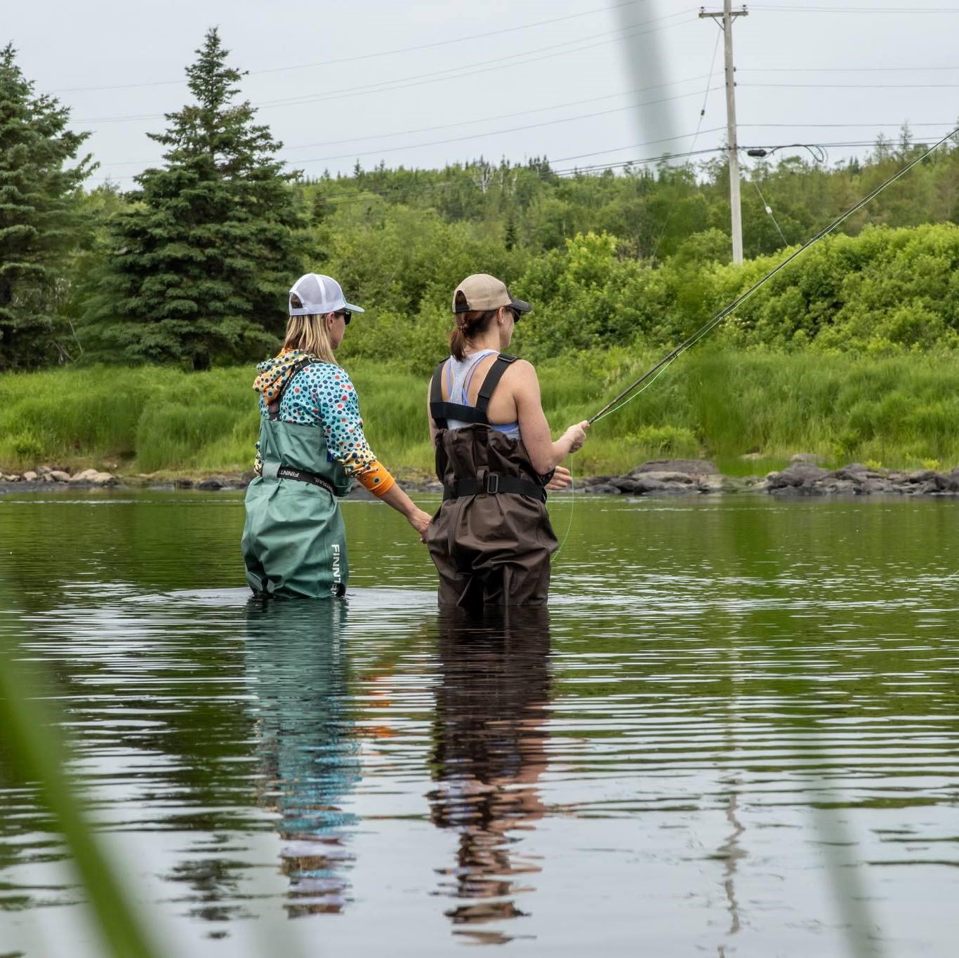 2 ladies fishing in river